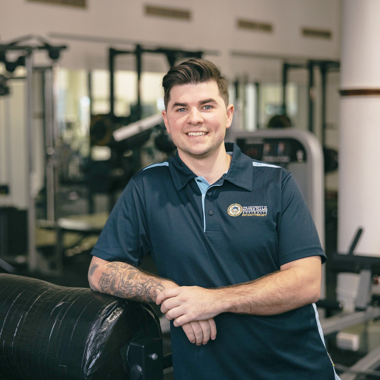 Male undergraduate physiotherapy Notre Dame student wearing a polo in the Fremantle campus gym