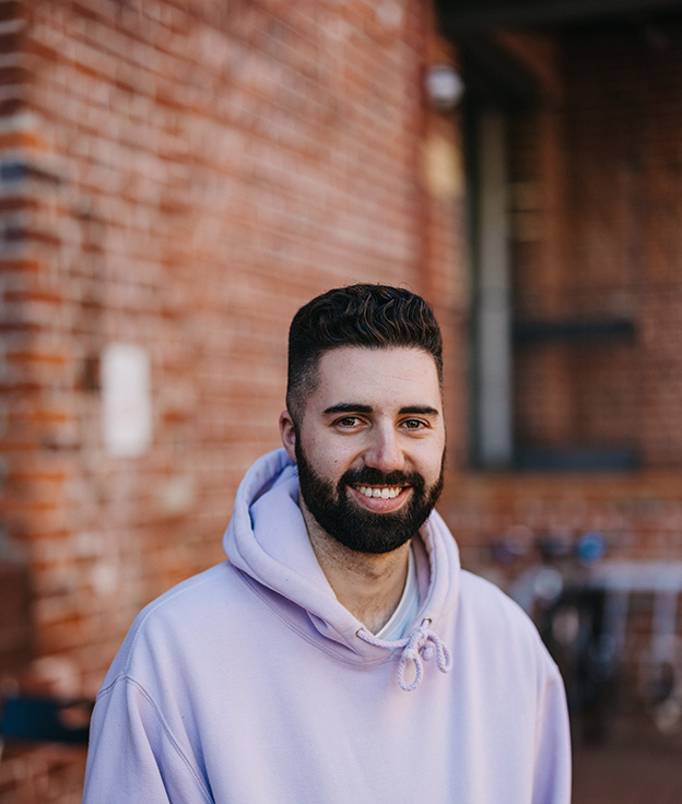 Undergraduate Notre Dame male student wearing a pink jumper